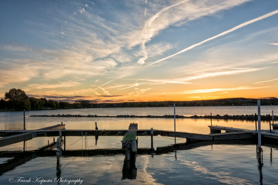 The morning sun breaks over empty slips signaling the end of the boating season. Most have been placed in storage for the upcoming winter season. Featured in the Power of Photography